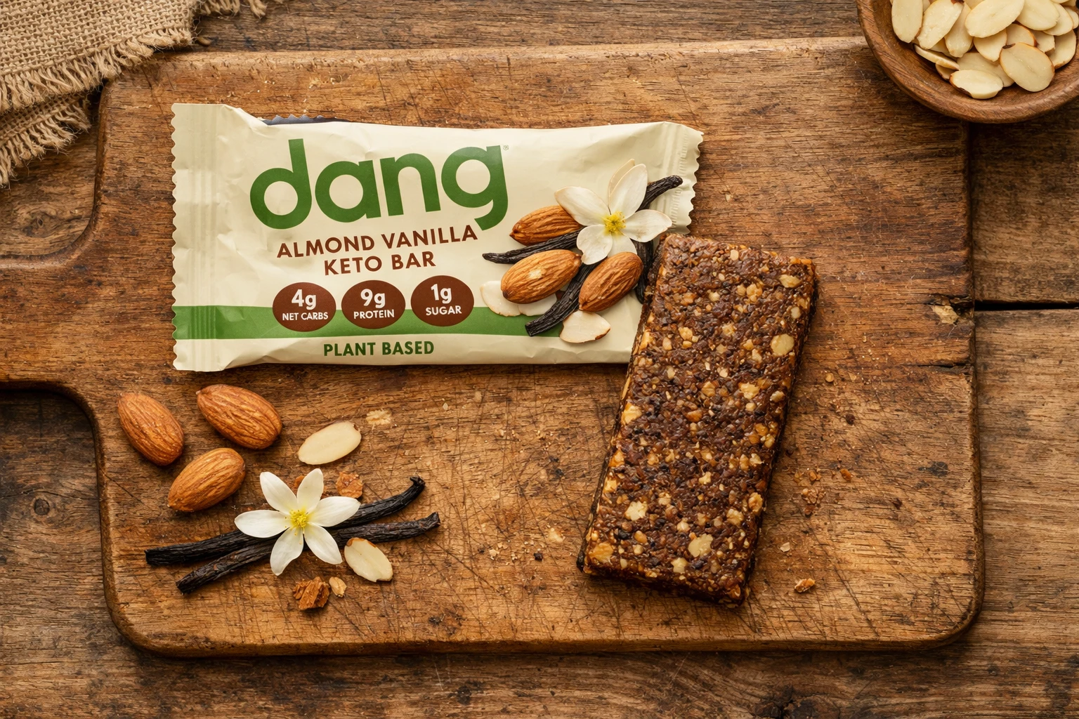 Dang Almond Vanilla keto bar unwrapped on wooden board - 200 calories per bar