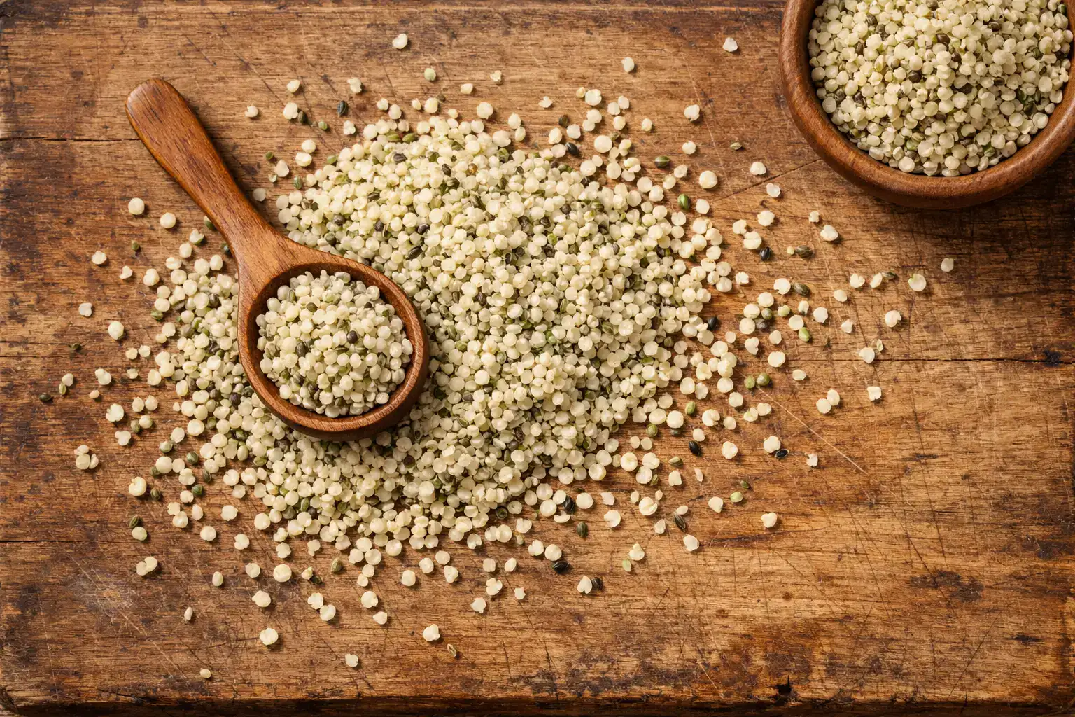 Fresh hulled hemp seeds on rustic wooden table - 166 calories per 30g serving