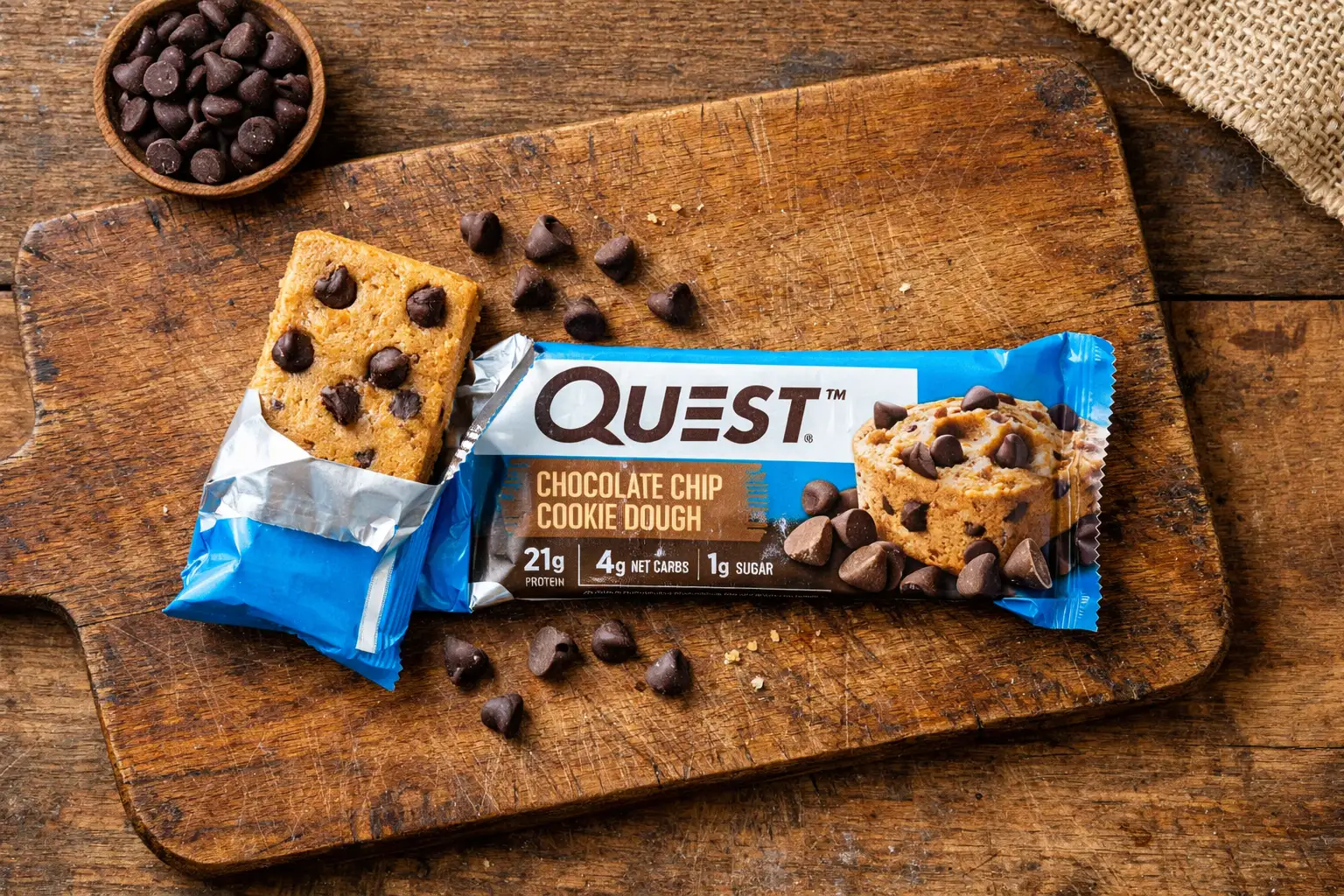 Quest Chocolate Chip Cookie Dough protein bar on rustic wooden table - 190 calories per bar