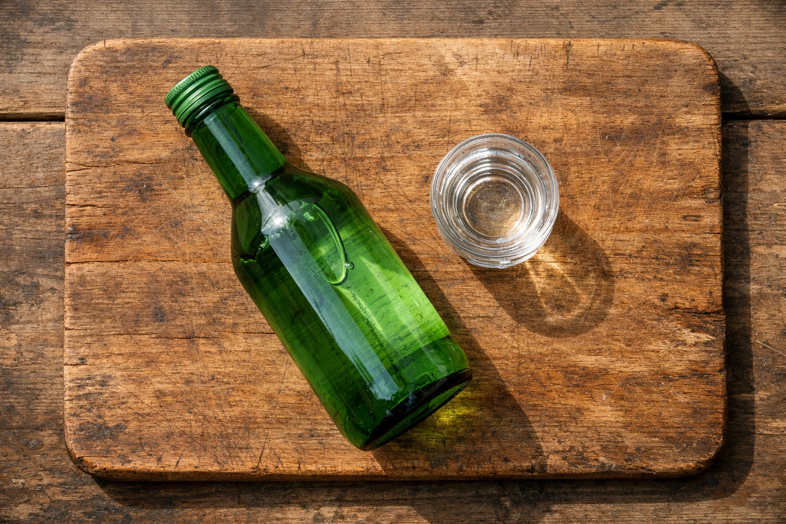 Fresh soju bottle and shot glass on rustic wooden table - 107 calories per 50ml shot