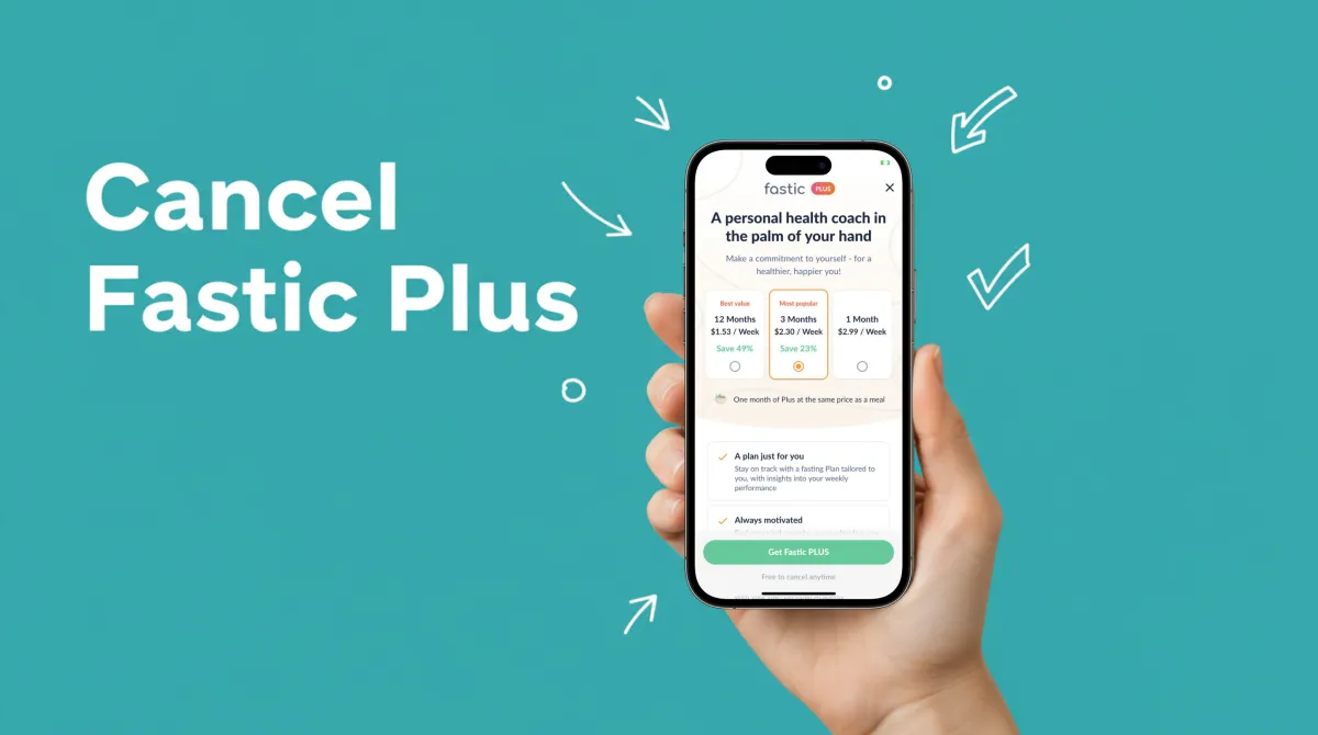 Person holding smartphone showing subscription settings on a clean white desk with notepad and water glass