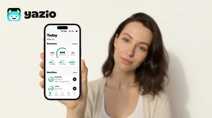 Smartphone running a calorie tracking app next to a healthy meal, illustrating a YAZIO PRO 2026 review