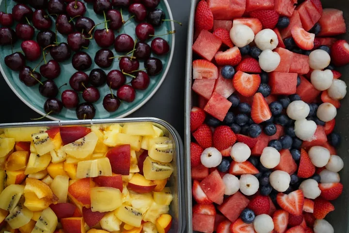 Healthy meal prep containers with colorful food arranged on a table