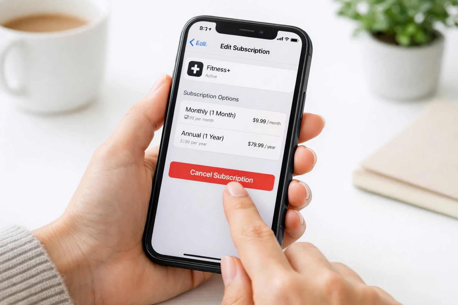 Person tapping cancel subscription on iPhone settings screen to avoid being charged