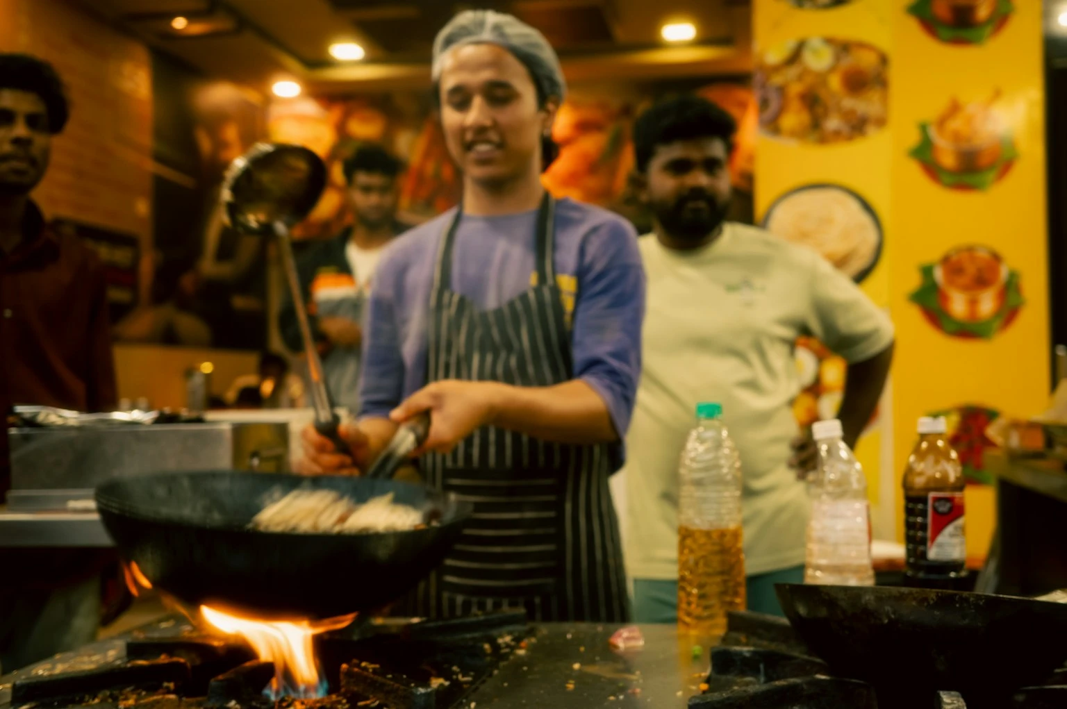 Chef actively cooking healthy food in a pan showing proper cooking technique