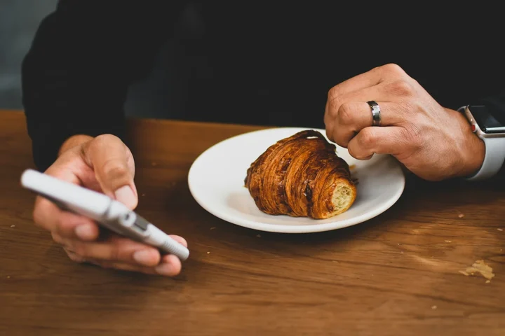 Person checking fasting app deals on their smartphone